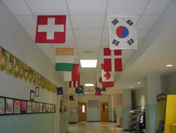 Flags in the school hallway represet countries of students' heritage